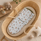 Cocon bébé motif ours et renards installé dans un univers enfant aux tons naturels et épurés.