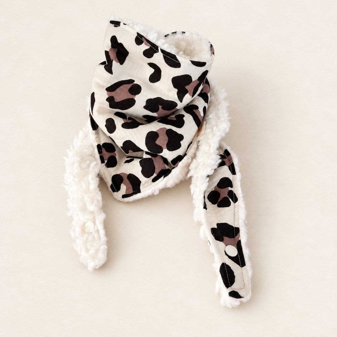 Foulard enfant écru à motif léopard noir et mauve, avec doublure blanche et deux pans ouverts, présenté sur fond crème.